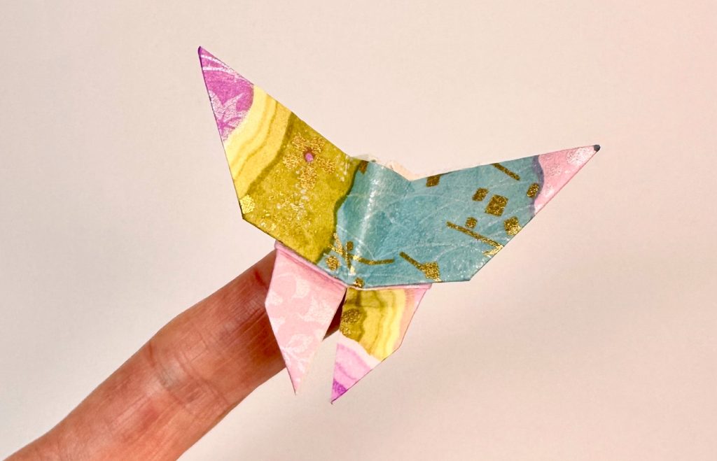 small origami butterfly on finger
